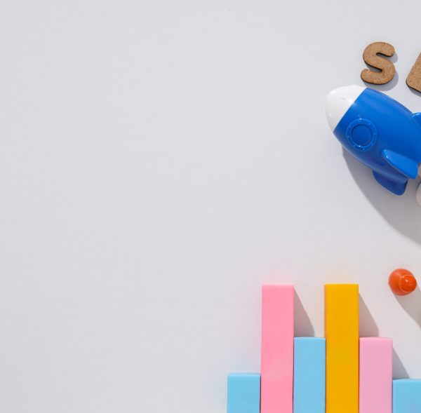 Diagram, letters and toy rocket on light background, space for text