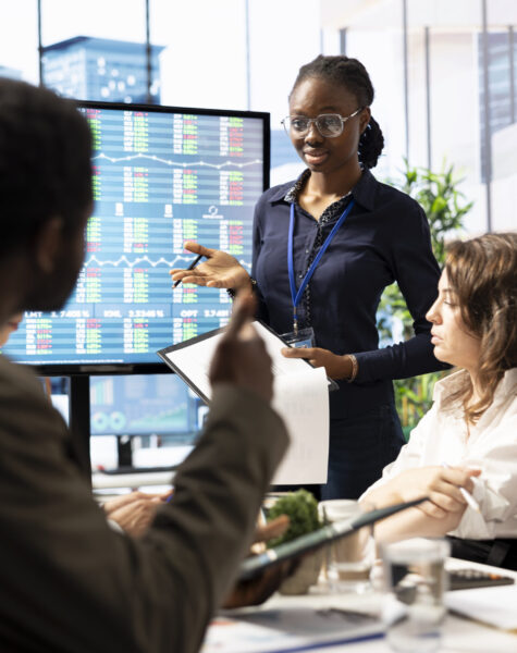 Advisory board members meeting in boardroom to establish future development plan, ensuring expansion goals for the multinational company. Studying big data insights to make informed decisions.