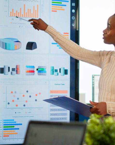 Corporate business people meeting in boardroom, african manager brainstorming with colleagues, discussing strategy, sharing problem, solving ideas collaborating in conference room of company