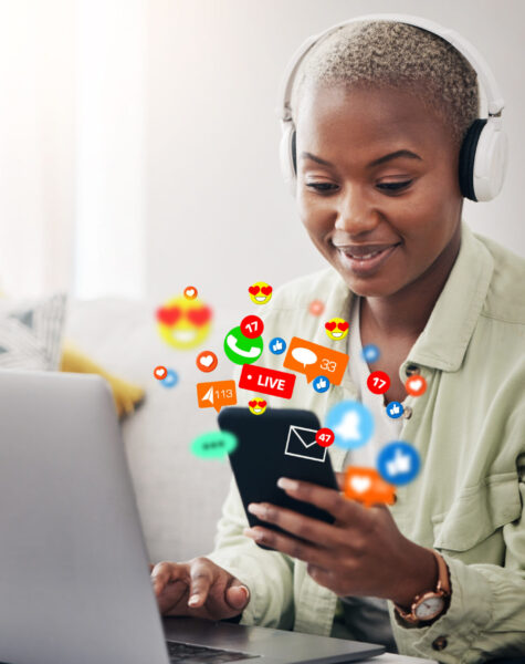 Laptop, social media icon or woman with phone for communication, message or online chat. Headphones, notification emojis or African person streaming music on mobile app on website or network at home.