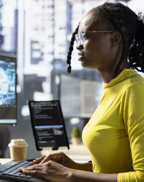 Worker conducting code review to fix bugs, identifying performance and technical issues with artificial intelligence company software. Woman debugging and optimizing code using AI
